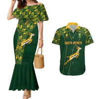Green off-shoulder mermaid dress with diamond pattern; matching rugby shirt with springbok graphic