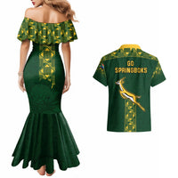 Green off-shoulder mermaid dress with geometric trim; matching rugby shirt with GO SPRINGBOKS back