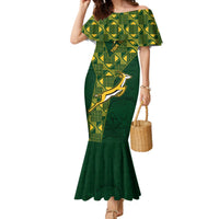 Green off-shoulder mermaid dress with patterned yoke panels and flared hem