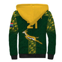 Green sherpa hoodie with yellow hood lining and rugby emblem on back