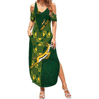 Green women's maxi dress with cold-shoulder V-neck and geometric rugby graphic