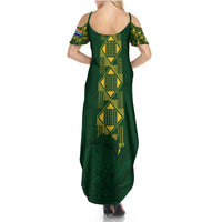 Green women's maxi dress with crisscross back straps, off-shoulder sleeves, geometric print