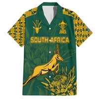 Green Hawaiian shirt with gold South Africa text, springbok and tropical leaf print