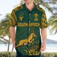 Green Hawaiian shirt worn by man, gold South Africa text and springbok front graphic