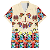 Beige button-up short-sleeve Hawaiian shirt with bird-and-shield style motif