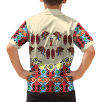 Beige button-up short-sleeve Hawaiian shirt on model, back bird-and-shield motif