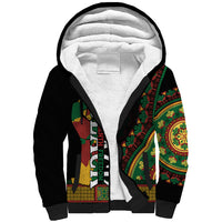 Black sherpa zip hoodie with white fleece hood and multicolor Africa-style patterned sleeves