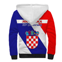 Blue and red sherpa zip hoodie with white hood lining, crest and 32nd Anniversary text