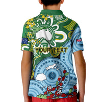 Green kids polo back with large animal graphic, blue geometric pattern and red accents