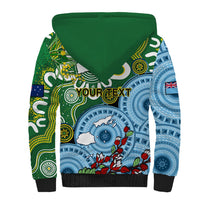 Sherpa hoodie with green back, blue tribal print and floral circle graphic, black cuffs