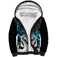 Sherpa hoodie with black outer and blue Maori-style artwork, sherpa-lined hood