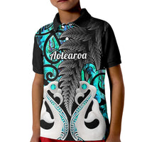 Kids black polo shirt with turquoise tribal fish and fern graphic, Aotearoa text