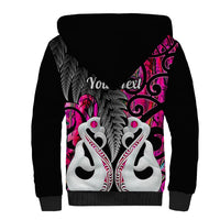 Black sherpa hoodie back view with large feathered pink graphic across shoulders