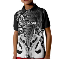 Kids black polo shirt with fern and Maori art graphic, buttoned collar