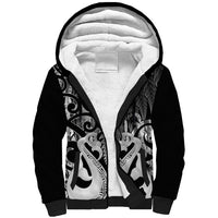Black sherpa zip-up hoodie with Maori-style graphic on hood and sleeves