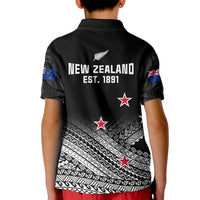 Kids black polo shirt back with New Zealand fern emblem, stars, and Maori tribal pattern