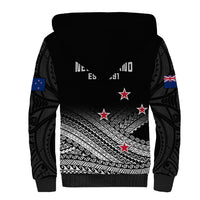 Black sherpa-lined hoodie back with Maori fern pattern, red stars, Union Jack sleeve patch