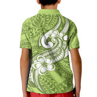Kids green polo shirt back view with white plumeria and tribal print, button collar