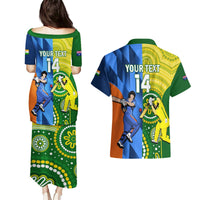 Matching cricket-themed puletasi dress and Hawaiian shirt in blue, green, and yellow.