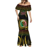 Black mermaid-style maxi dress with off-shoulder neckline and circular logo graphic