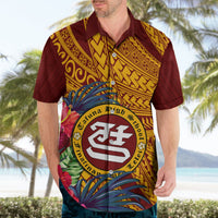 Maroon Hawaiian shirt with tropical flower print and circular crest on chest