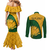 Back view: yellow mermaid dress and green button-up shirt with South Africa Unity in Diversity text