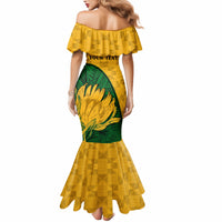 Yellow mermaid dress with ruffled off-shoulder neckline and green protea side panel