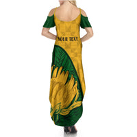Women’s yellow maxi dress with green sleeves and protea floral print, scoop back