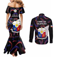 Black off-shoulder mermaid dress and long-sleeve button shirt, both with back graphic