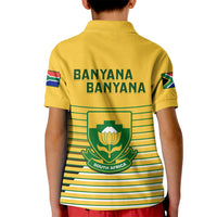 Kids yellow soccer polo shirt with Banyana Banyana text, crest, and green striped back