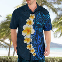 Blue Hawaiian shirt on adult model, plumeria flowers and Polynesian blue pattern
