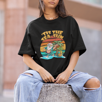 Black crewneck graphic T-shirt with Santa-and-sea scene print worn by model