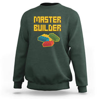 Dark forest green sweatshirt with “Master Builder” text and colorful block builder graphic