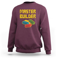 Maroon sweatshirt with “Master Builder” text and colorful block builder graphic