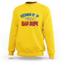 Daisy yellow sweatshirt with “Corn Pop was a bad dude” graphic on the chest