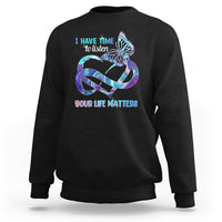 Black sweatshirt with colorful butterfly graphic and “I have time to listen / Your life matters”.
