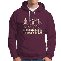 Maroon hoodie with moon-phase skeleton dancers graphic and 'It's Just A Phase' text