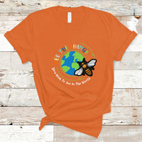 Orange T-shirt with circular bee and globe graphic and slogan