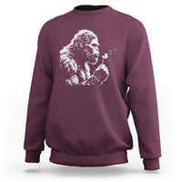 Bigfoot Blowing Dandelion Flower Graphic Sweatshirt Whimsical Sasquatch Profile Artistic Vintage Distressed