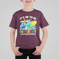 Kids autism awareness T-shirt, maroon, front whale graphic with “It’s OK to be Different”