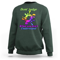 Forest green sweatshirt with autism puzzle graphic: “Don't judge” and “What you don't Understand”