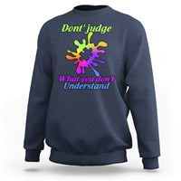 Navy sweatshirt with autism puzzle graphic: “Don't judge” and “What you don't Understand”