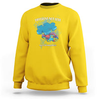 Daisy yellow crewneck sweatshirt with “DIFFERENT NOT LESS” autism awareness graphic