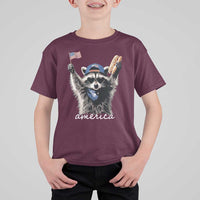 Funny America Raccoon Happy 4th of July T Shirt For Kid Holding Hotdog and US Flag Patriotic Graphic