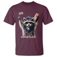 Funny America Raccoon Happy 4th of July T Shirt Holding Hotdog and US Flag Patriotic Graphic