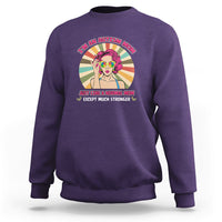 Purple sweatshirt with front “I’m an Autism Mom” graphic and colorful character.