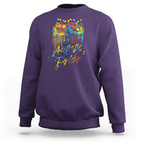 Purple sweatshirt with colorful "Autistic Pride" graphic and glasses on back