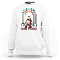 White crewneck sweatshirt with rainbow Jesus graphic and text "God is working".