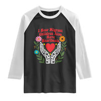 I Hear Migrant Children Also Have Heartbeats Raglan Shirt Groovy Retro Floral Hands Heart Social Justice