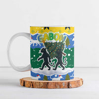 Gabon Christmas Ceramic Mug with Black Panthers Carrying Tree and Green Yellow Snowflake Pattern - Wonder Print Shop